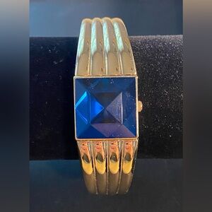 Gruen Quartz Women's Bangle Gold-tone Watch Hidden Dial with Faceted Blue Gem